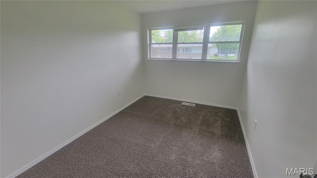 2490 Northridge Pl, Florissant, MO 63033 - empty room with dark carpet and baseboards