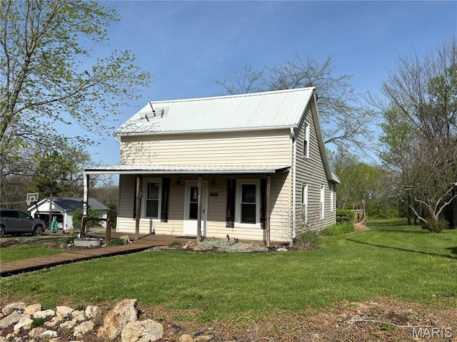 1909 W Springfield Rd, Saint Clair, MO 63077 - view of front of house with a porch, a front yard, and metal roof
