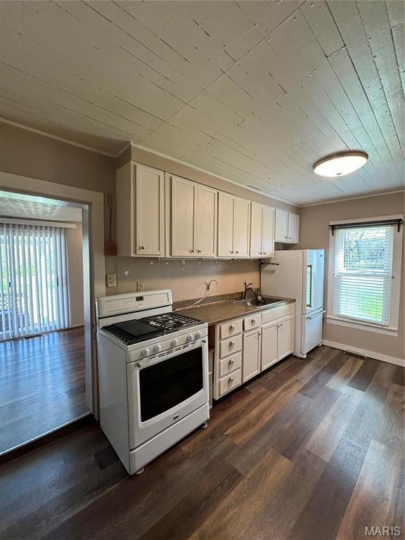 1909 W Springfield Rd, Saint Clair, MO 63077 - kitchen with white appliances, dark wood finished floors, wood ceiling, white cabinets, and a sink