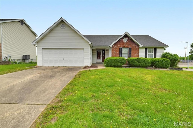 view of front facade featuring an attached garage, concrete driveway, a front yard, brick siding, and central AC unit