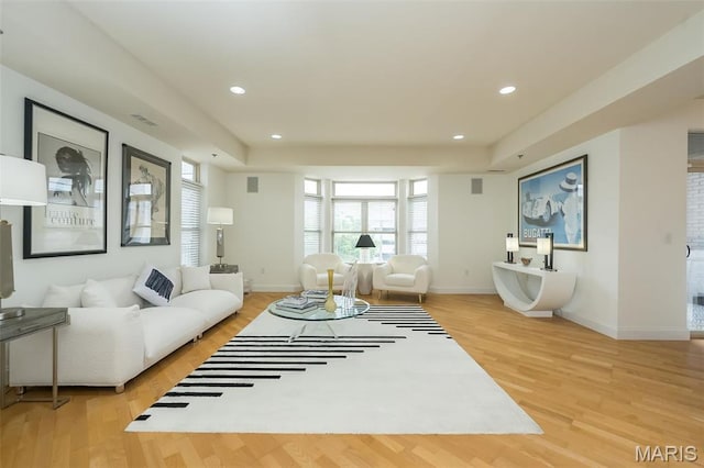 living room featuring light wood-type flooring, recessed lighting, and baseboards