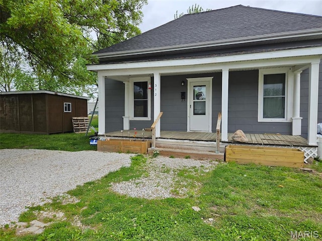 312 S Locust St, Monroe City, MO 63456 - view of front of home featuring a porch, roof with shingles, and a front lawn