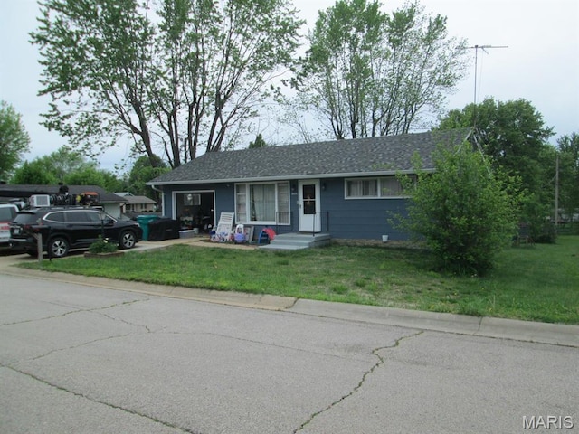 ranch-style home with a front yard, a garage, and driveway