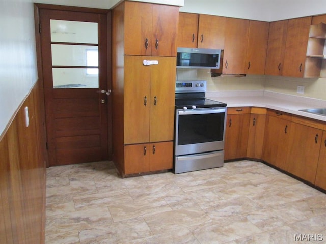 11 W S St, Gerald, MO 63037 - kitchen featuring appliances with stainless steel finishes, brown cabinets, light countertops, and open shelves
