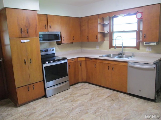 11 W S St, Gerald, MO 63037 - kitchen featuring stainless steel appliances, a sink, light countertops, and brown cabinets