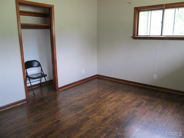 11 W S St, Gerald, MO 63037 - unfurnished bedroom featuring dark wood-type flooring, baseboards, and a closet