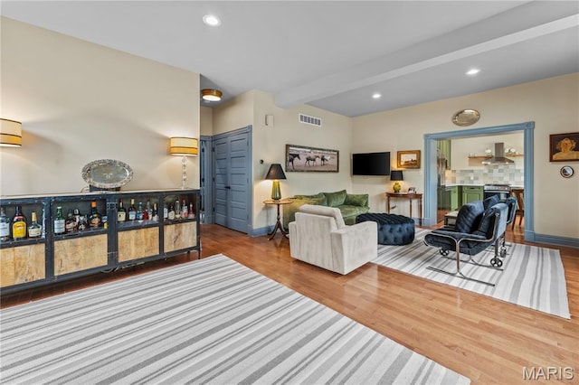 3559 Halliday Ave Unit 102, Saint Louis, MO 63118 - living area with baseboards, beam ceiling, wood finished floors, recessed lighting, and a bar