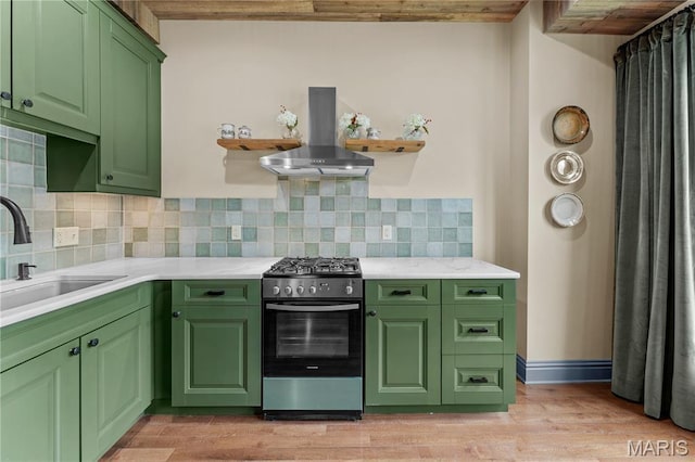 3559 Halliday Ave Unit 102, Saint Louis, MO 63118 - kitchen with stainless steel gas range, island exhaust hood, a sink, green cabinets, and light countertops