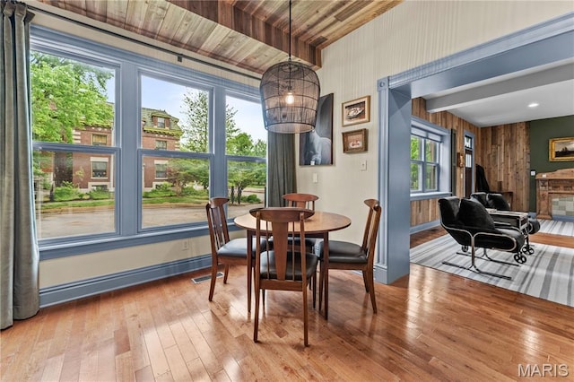 3559 Halliday Ave Unit 102, Saint Louis, MO 63118 - dining area with wood-type flooring, baseboards, wooden walls, and wood ceiling