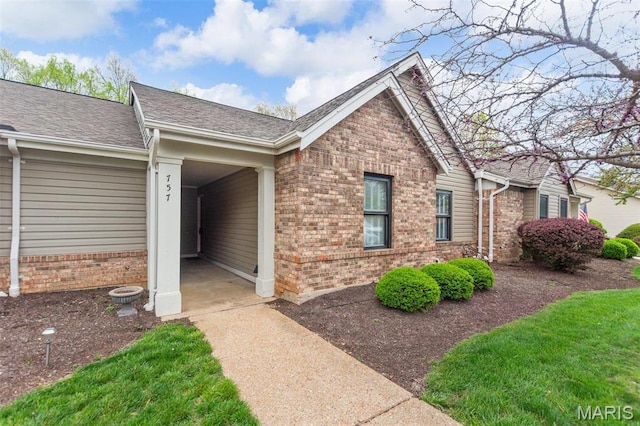 757 Windy Ridge Dr Unit B, Ballwin, MO 63021 - view of home's exterior with brick siding and roof with shingles