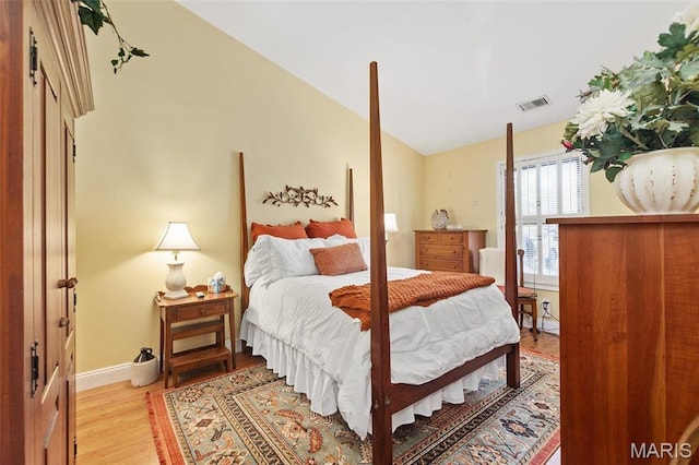757 Windy Ridge Dr Unit B, Ballwin, MO 63021 - bedroom with light wood-type flooring, lofted ceiling, and baseboards