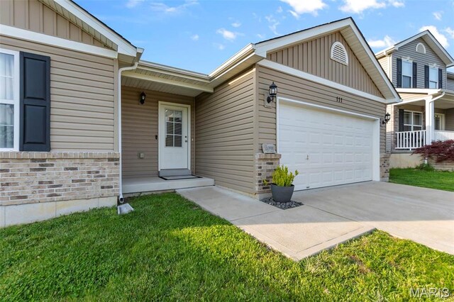 111 Hammond Dr, Herculaneum, MO 63048 - view of front of property featuring board and batten siding, a garage, driveway, and a front yard