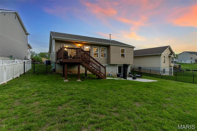 111 Hammond Dr, Herculaneum, MO 63048 - back of house at dusk featuring stairway, a wooden deck, and a patio