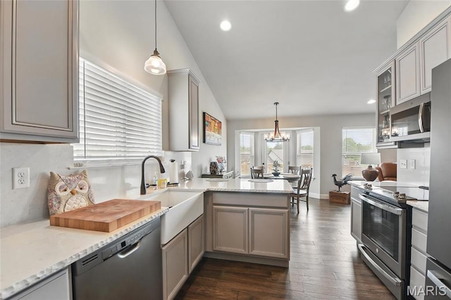 23 Austin Oaks Dr, Moscow Mills, MO 63362 - kitchen with a peninsula, stainless steel appliances, lofted ceiling, dark wood-style floors, and gray cabinetry
