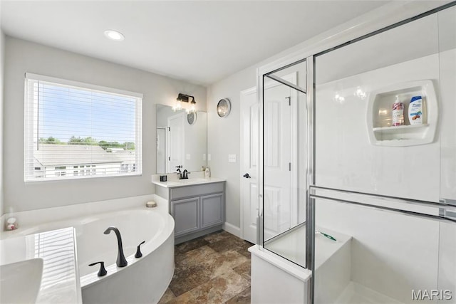 23 Austin Oaks Dr, Moscow Mills, MO 63362 - bathroom featuring vanity, a bath, stone finish flooring, a shower stall, and recessed lighting