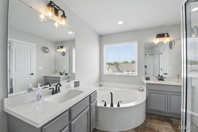 23 Austin Oaks Dr, Moscow Mills, MO 63362 - bathroom featuring a bath, two vanities, a stall shower, recessed lighting, and stone finish floors