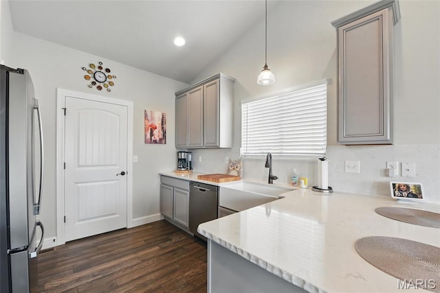 23 Austin Oaks Dr, Moscow Mills, MO 63362 - kitchen with gray cabinetry, vaulted ceiling, appliances with stainless steel finishes, dark wood-style floors, and pendant lighting