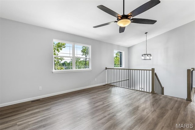 943 Stone Gate Dr, De Soto, MO 63020 - spare room featuring wood finished floors, vaulted ceiling, baseboards, a ceiling fan, and a chandelier