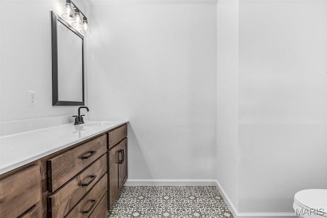 943 Stone Gate Dr, De Soto, MO 63020 - bathroom featuring vanity, toilet, and baseboards