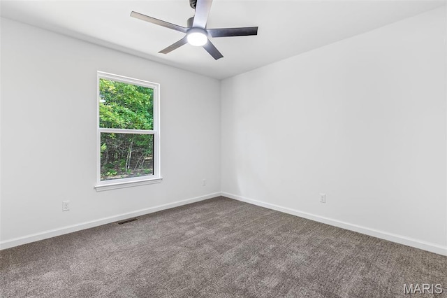943 Stone Gate Dr, De Soto, MO 63020 - unfurnished room featuring a ceiling fan, dark colored carpet, and baseboards