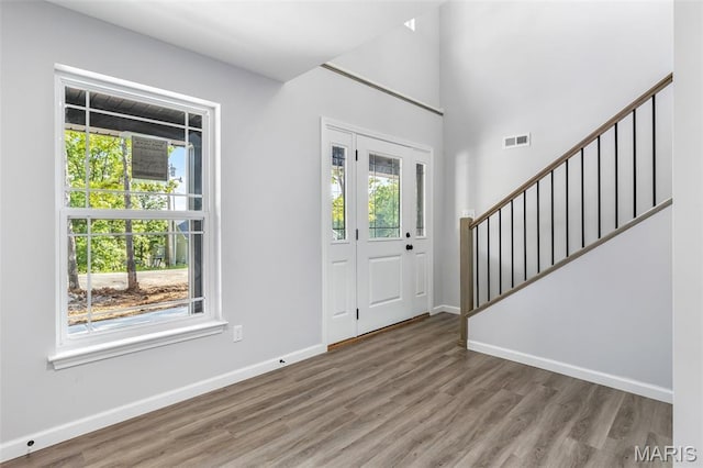 943 Stone Gate Dr, De Soto, MO 63020 - foyer entrance with baseboards, stairs, wood finished floors, healthy amount of natural light, and a high ceiling