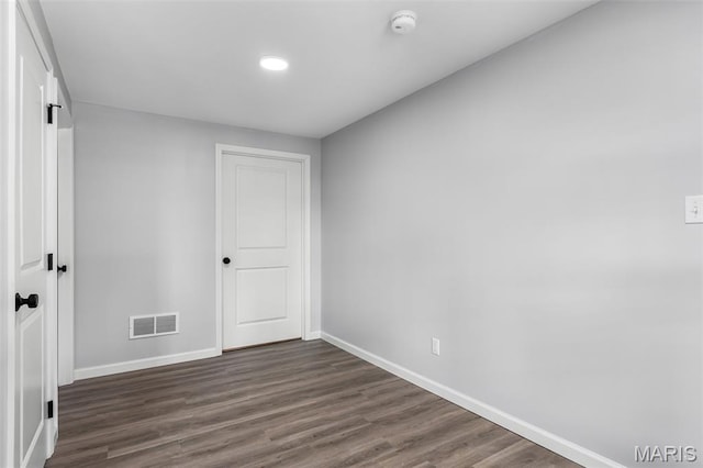 943 Stone Gate Dr, De Soto, MO 63020 - unfurnished bedroom with baseboards, dark wood-style flooring, and a closet