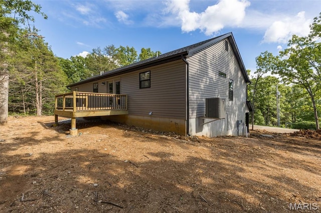 943 Stone Gate Dr, De Soto, MO 63020 - view of side of home with a wooden deck and central AC unit