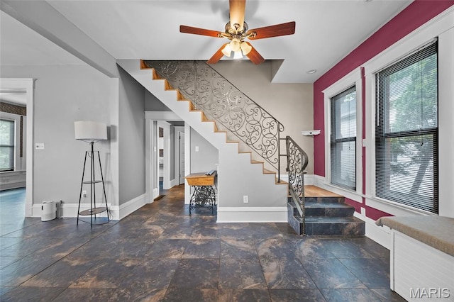 27 N Taylor Ave, Crystal City, MO 63019 - foyer entrance with stairway, baseboards, stone finish floors, and a ceiling fan