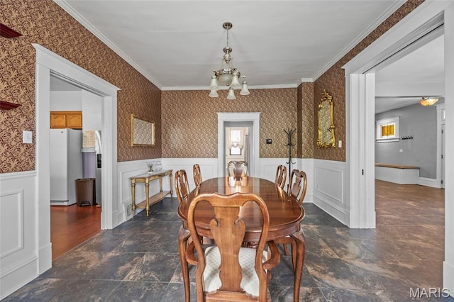 27 N Taylor Ave, Crystal City, MO 63019 - dining space with a chandelier, a wainscoted wall, ornamental molding, dark stone finish floors, and wallpapered walls