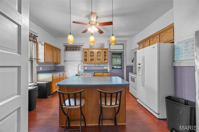 27 N Taylor Ave, Crystal City, MO 63019 - kitchen with white appliances, a sink, a kitchen island with sink, a ceiling fan, and dark wood-style flooring