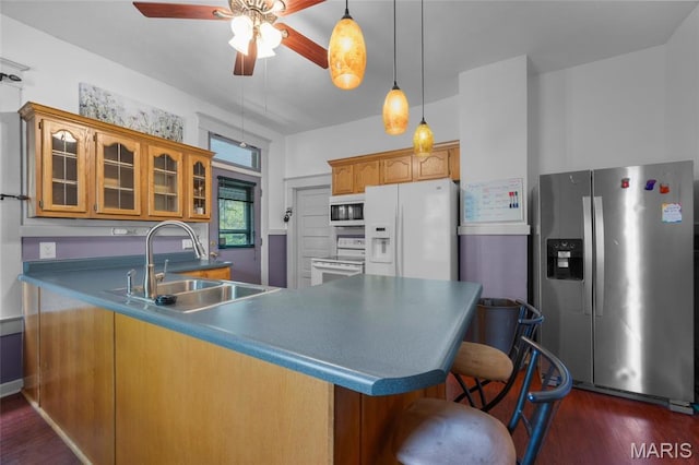 27 N Taylor Ave, Crystal City, MO 63019 - kitchen with white appliances, a peninsula, a sink, glass insert cabinets, and dark wood finished floors