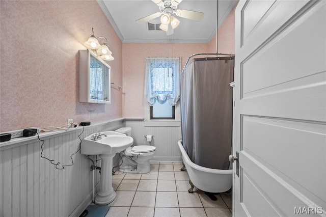 27 N Taylor Ave, Crystal City, MO 63019 - full bathroom with tile patterned flooring, toilet, a wainscoted wall, ceiling fan, and crown molding