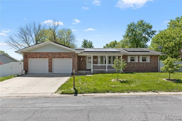 511 Ruddy Ct, Troy, IL 62294 - single story home with a garage, brick siding, solar panels, concrete driveway, and a porch