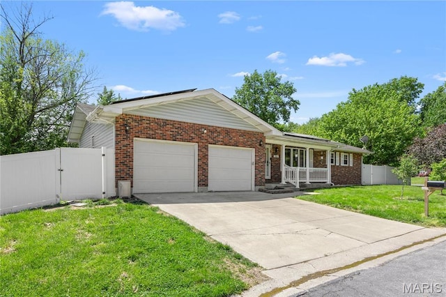 511 Ruddy Ct, Troy, IL 62294 - single story home with an attached garage, brick siding, concrete driveway, covered porch, and a gate