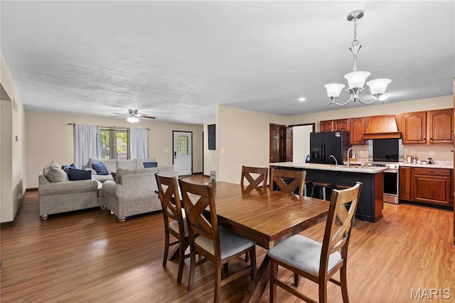 511 Ruddy Ct, Troy, IL 62294 - dining room featuring a chandelier, light wood finished floors, and a ceiling fan