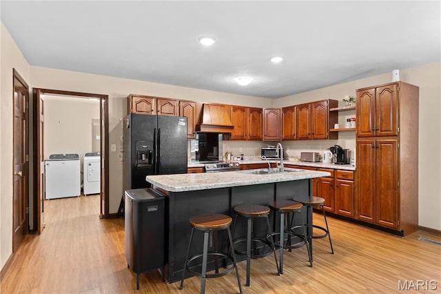 511 Ruddy Ct, Troy, IL 62294 - kitchen featuring black fridge with ice dispenser, independent washer and dryer, light wood finished floors, open shelves, and recessed lighting