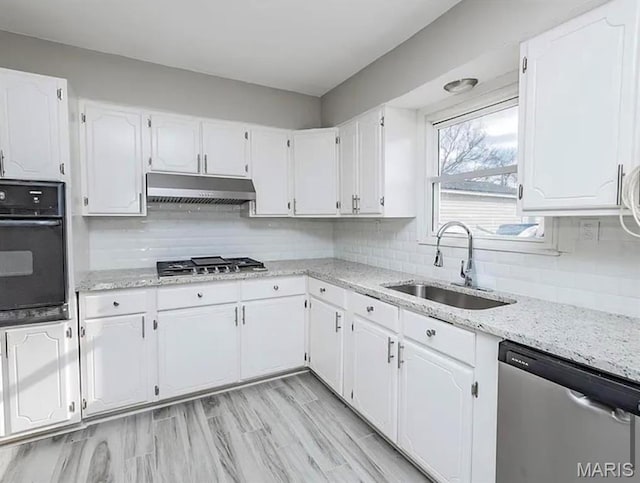 5108 S Gem Dr, High Ridge, MO 63049 - kitchen with appliances with stainless steel finishes, under cabinet range hood, and white cabinetry