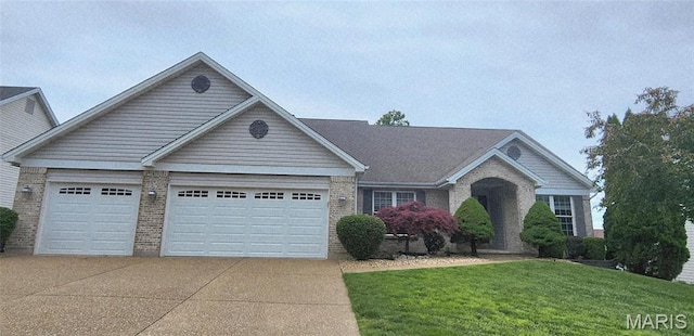 view of front of home featuring brick siding, a garage, concrete driveway, and a front lawn