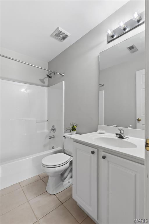 84 Timber Creek Dr Unit 8D, Ofallon, MO 63368 - bathroom with tile patterned flooring, toilet, vanity, and washtub / shower combination