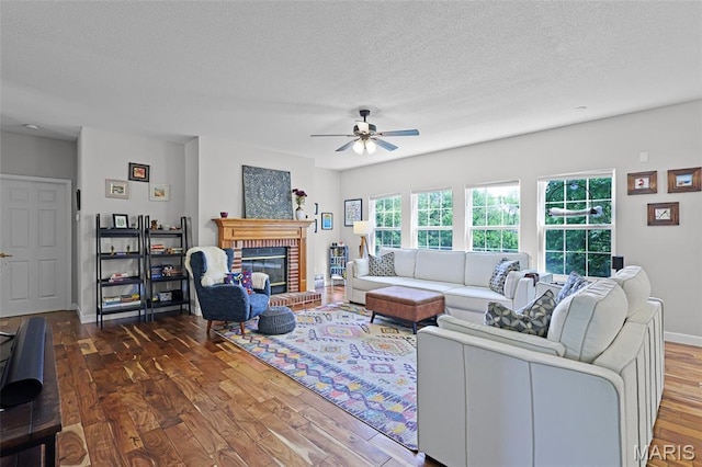 30 Shiloh Ct, Edwardsville, IL 62025 - living room featuring wood finished floors, ceiling fan, a textured ceiling, a fireplace, and baseboards