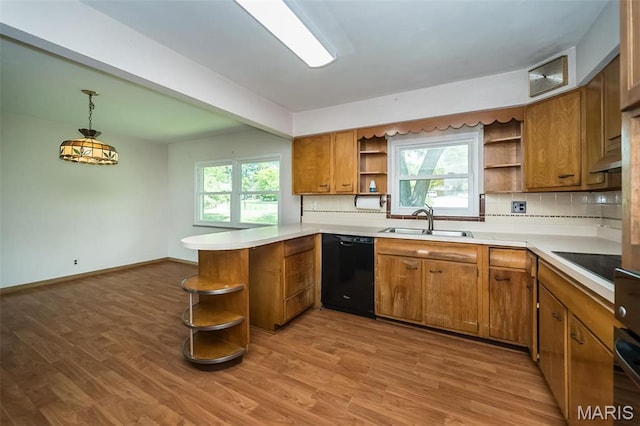 kitchen with open shelves, black appliances, a sink, brown cabinetry, and a peninsula