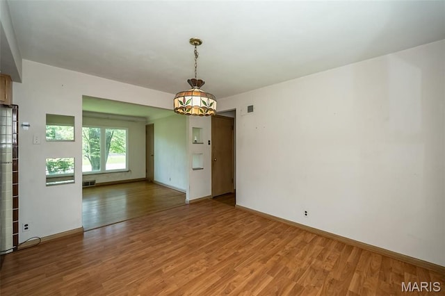 unfurnished room with light wood-style floors and baseboards