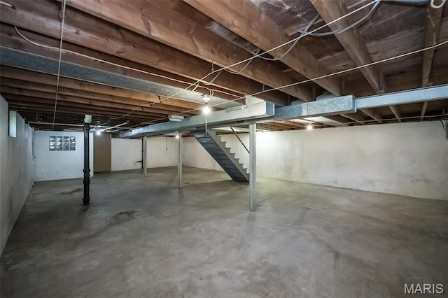 unfinished below grade area featuring stairway