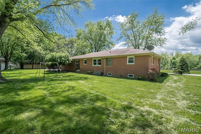 back of property with a lawn, central AC, and brick siding