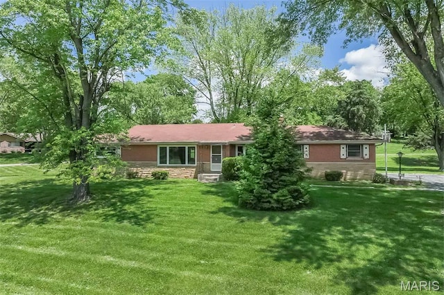 view of front of property with stone siding and a front lawn