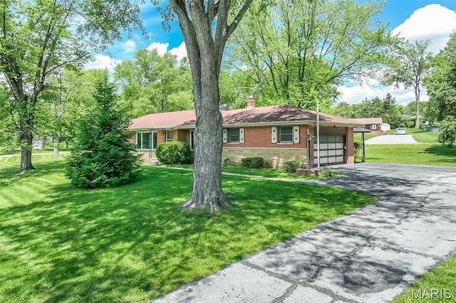 ranch-style home featuring an attached garage, driveway, a chimney, a front lawn, and brick siding