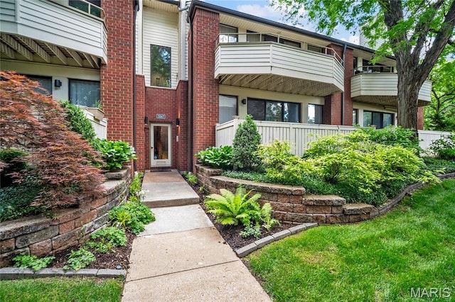 5567 Waterman Blvd Unit D, Saint Louis, MO 63112 - view of exterior entry with a balcony and brick siding