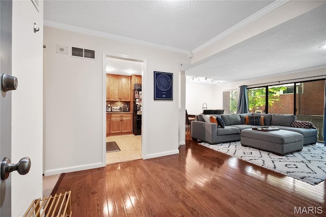 5567 Waterman Blvd Unit D, Saint Louis, MO 63112 - living room featuring light wood-type flooring, baseboards, crown molding, and track lighting