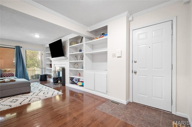 5567 Waterman Blvd Unit D, Saint Louis, MO 63112 - living room featuring crown molding, baseboards, a fireplace, a textured ceiling, and wood finished floors