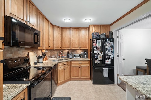 5567 Waterman Blvd Unit D, Saint Louis, MO 63112 - kitchen with black appliances, a sink, decorative backsplash, light stone counters, and light tile patterned floors